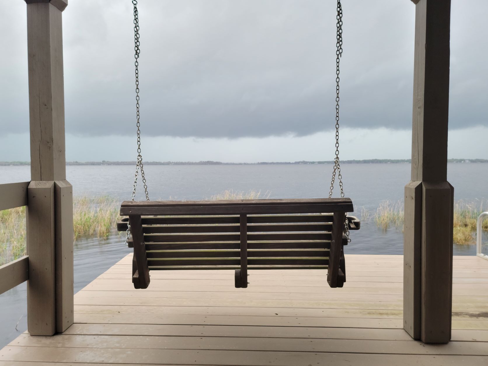 Dock shelters from rainstorm approaching on Lake Minnehaha in Central Florida 