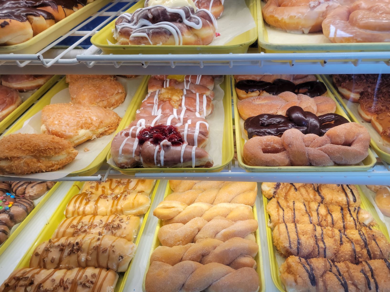 The donut display at a bakery calls out invitations to enjoy more.