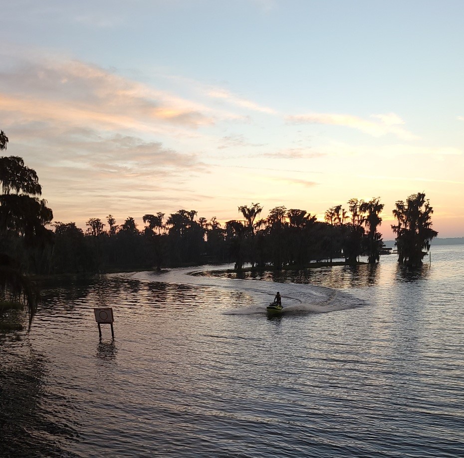 Jet ski rider greets a new day with adventure touring the Clermont Chain of Lakes in Central Florida